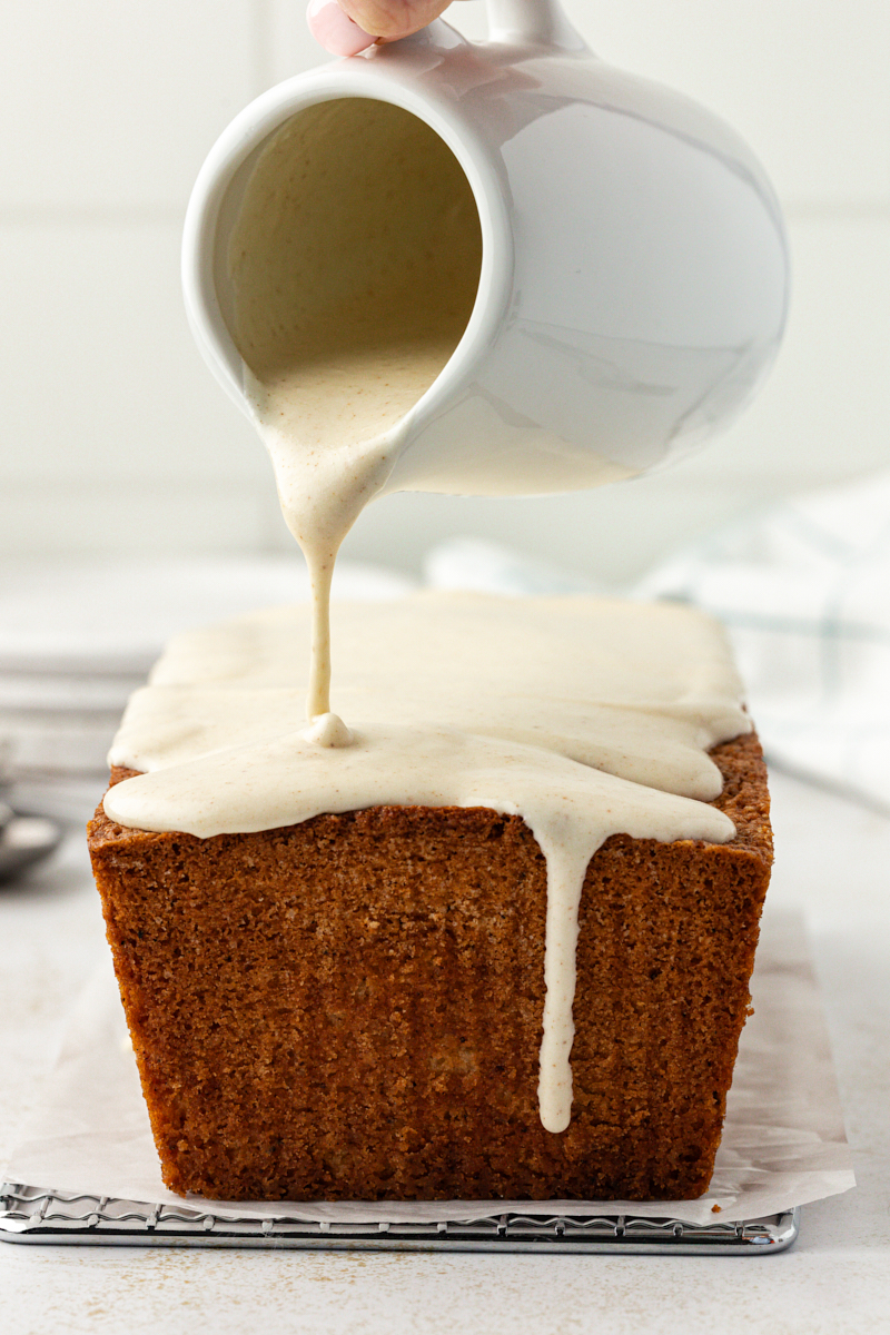 brown butter cream cheese glaze being poured over brown butter pound cake