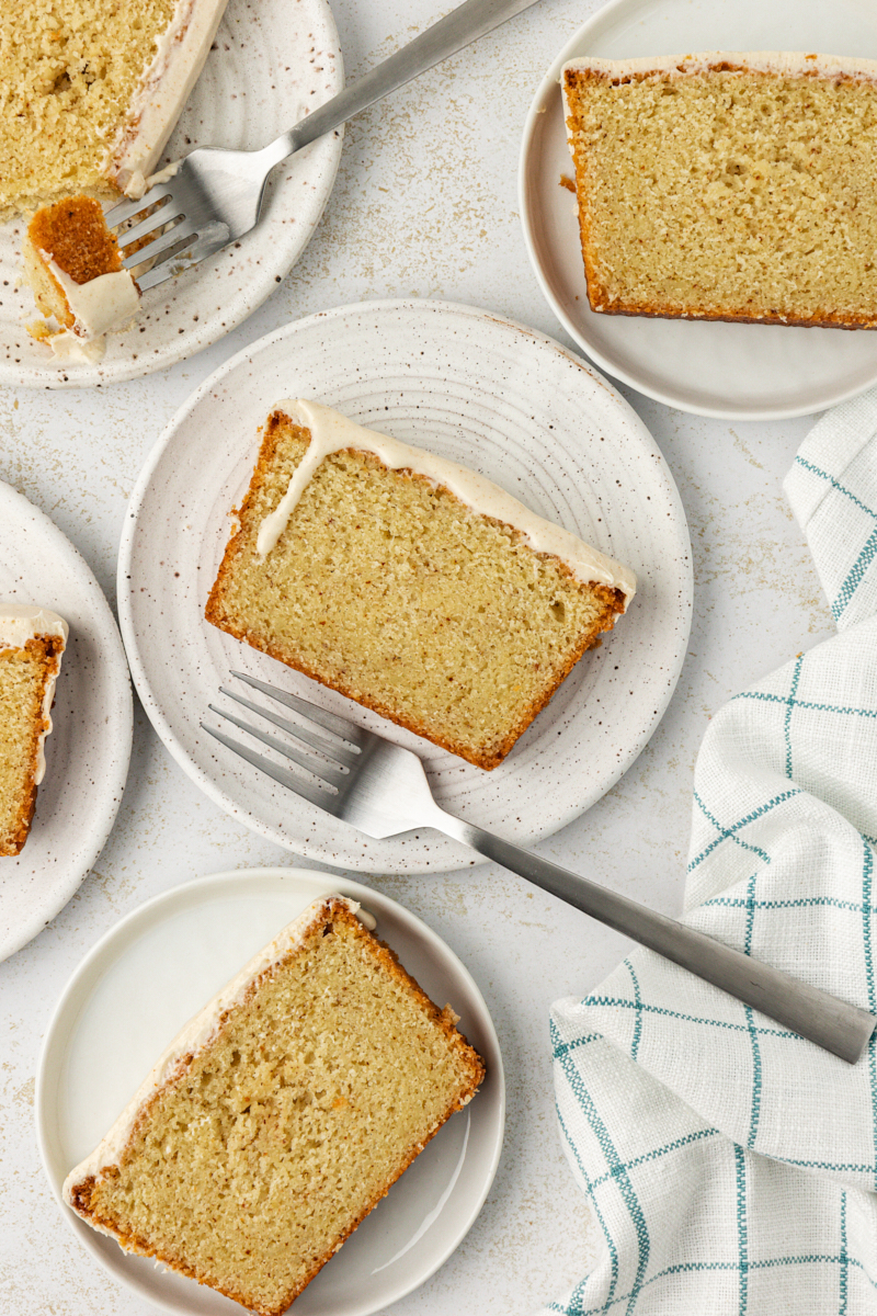 overhead view of slices of brown butter pound cake on white plates