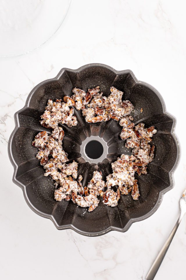 overhead view of nutty topping in the bottom of a Bundt pan