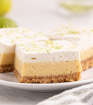 three key lime pie bars on a white plate