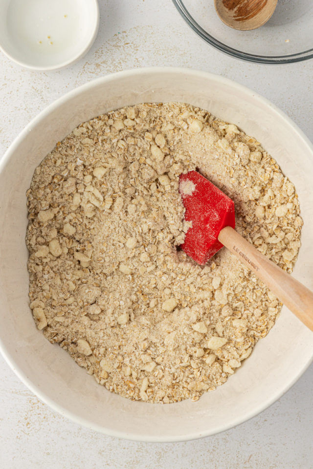 overhead view of raspberry oatmeal bars crust mixture in a mixing bowl