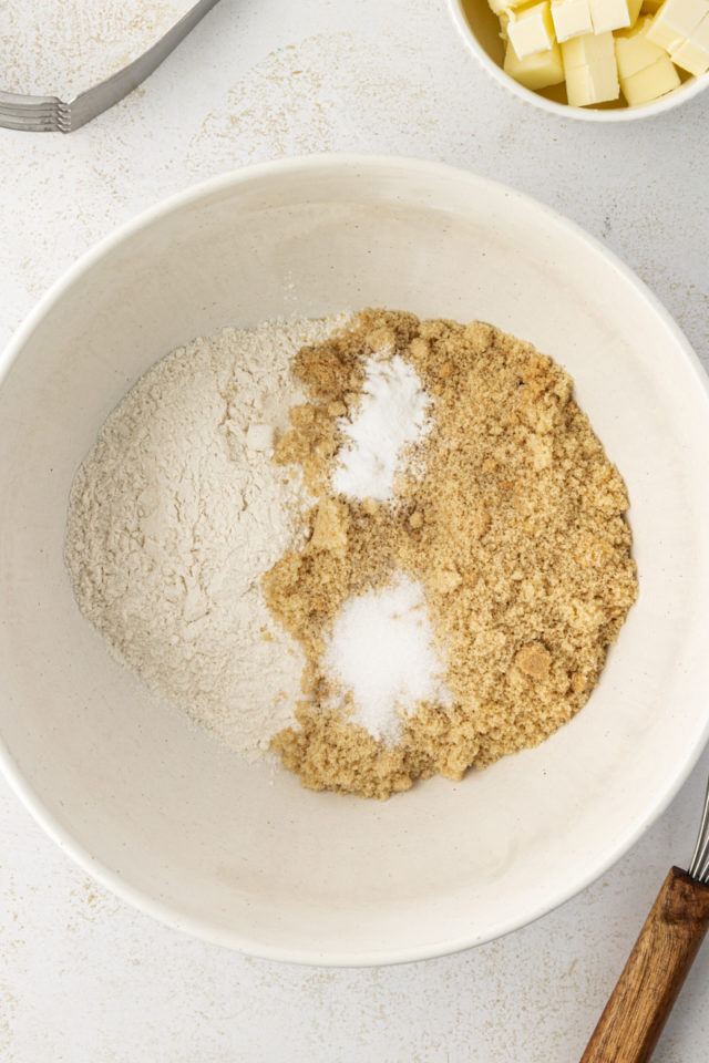 overhead view of brown sugar, flour, baking soda, and salt in a mixing bowl