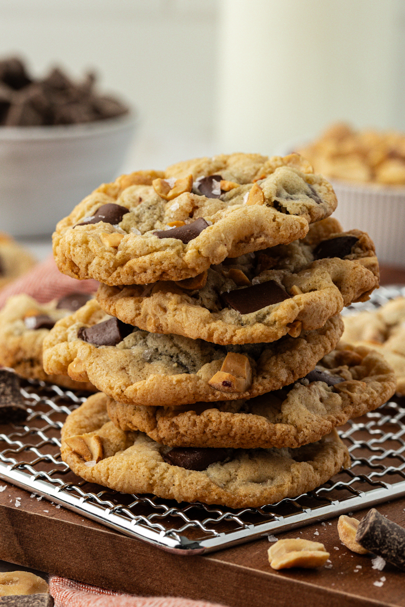 a stack of five peanut chocolate chunk cookies on a wire rack