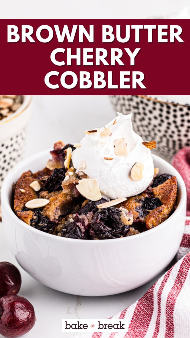 a bowl of brown butter cherry cobbler topped with whipped cream and sliced almonds; text overlay "brown butter cherry cobbler bake or break"