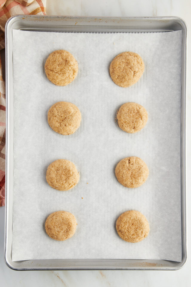 Overhead view of chai sugar cookies on parchment-lined baking sheet