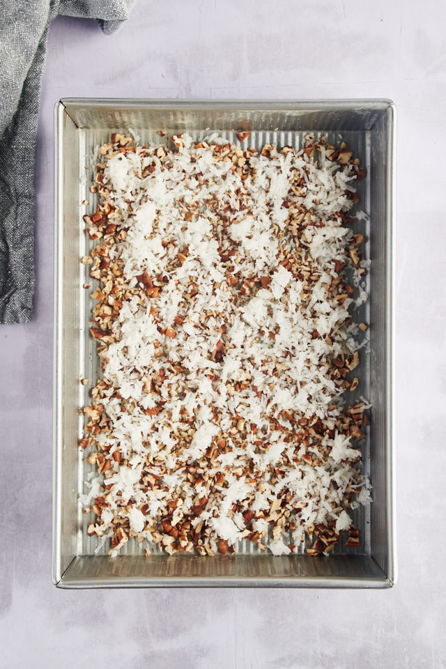 Overhead view of coconut and pecans in pan