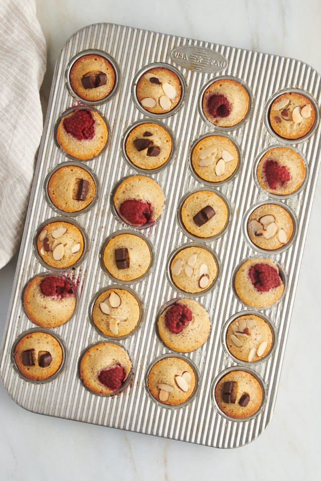 overhead view of freshly baked financiers in a mini muffin pan