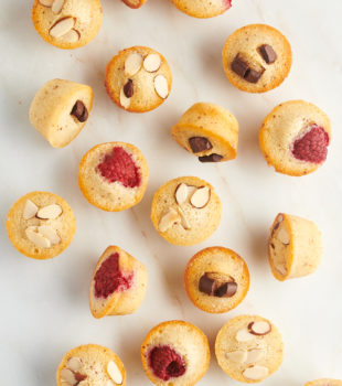 overhead view of financiers scattered over a marble countertop
