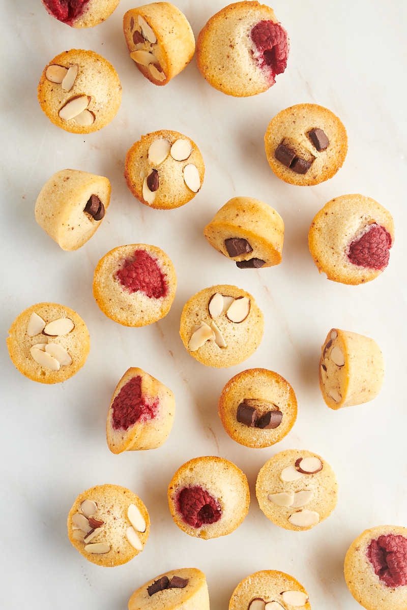 overhead view of financiers scattered over a marble countertop