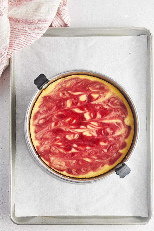 Overhead view of white chocolate raspberry cheesecake in springform pan