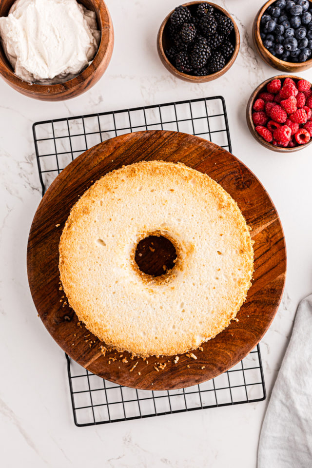 overhead view of angel food cake on a wooden serving tray