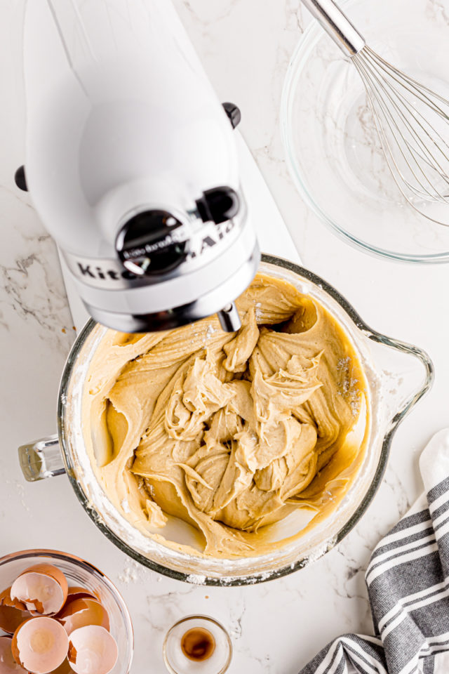 overhead view of mixed cream cheese pound cake batter in the bowl of a stand mixer