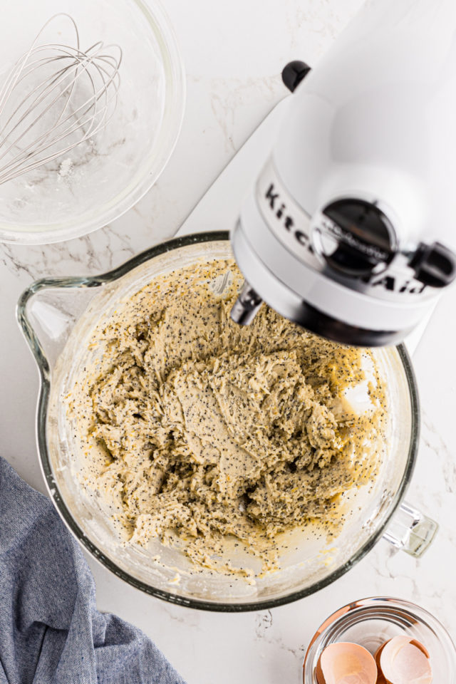 overhead view of lemon poppy seed cookie dough in the bowl of a stand mixer