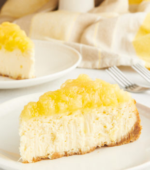 Side view of pineapple cheesecake slice on plate