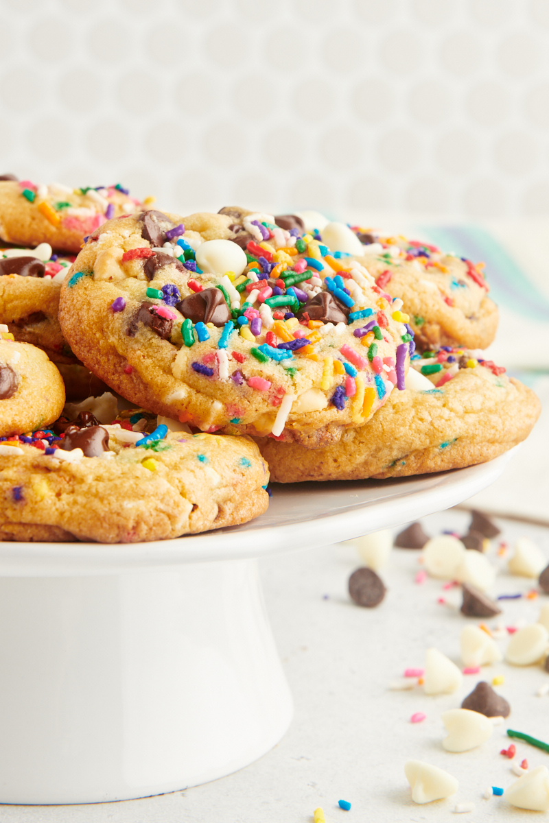 sprinkle chocolate chip cookies on a white cake stand