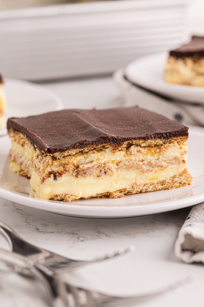 a slice of chocolate eclair cake on a white plate