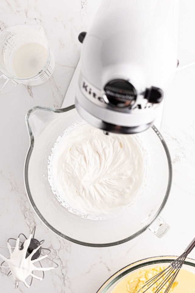 overhead view of whipped cream in the bowl of a stand mixer