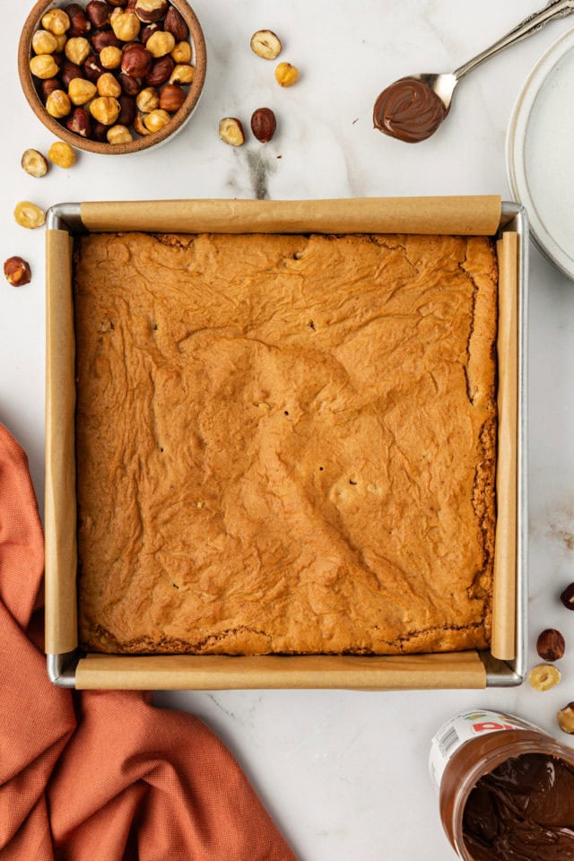 overhead view of freshly baked hazelnut blondies in a square baking pan
