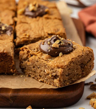 hazelnut blondies on a wooden cutting board