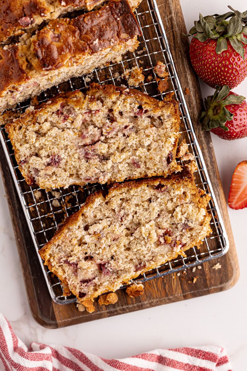 overhead view of sliced strawberry cream cheese bread on a wooden cutting board