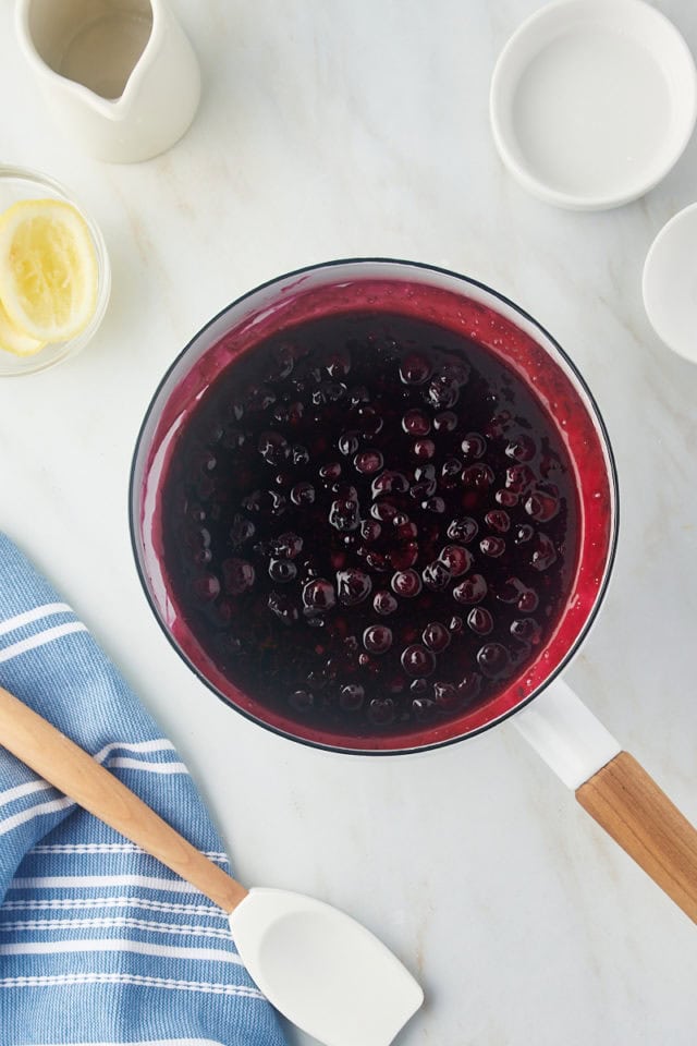 overhead view of cooked blueberry compote in a white saucepan