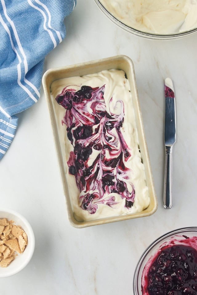 overhead view of blueberry compote swirled into cheesecake ice cream