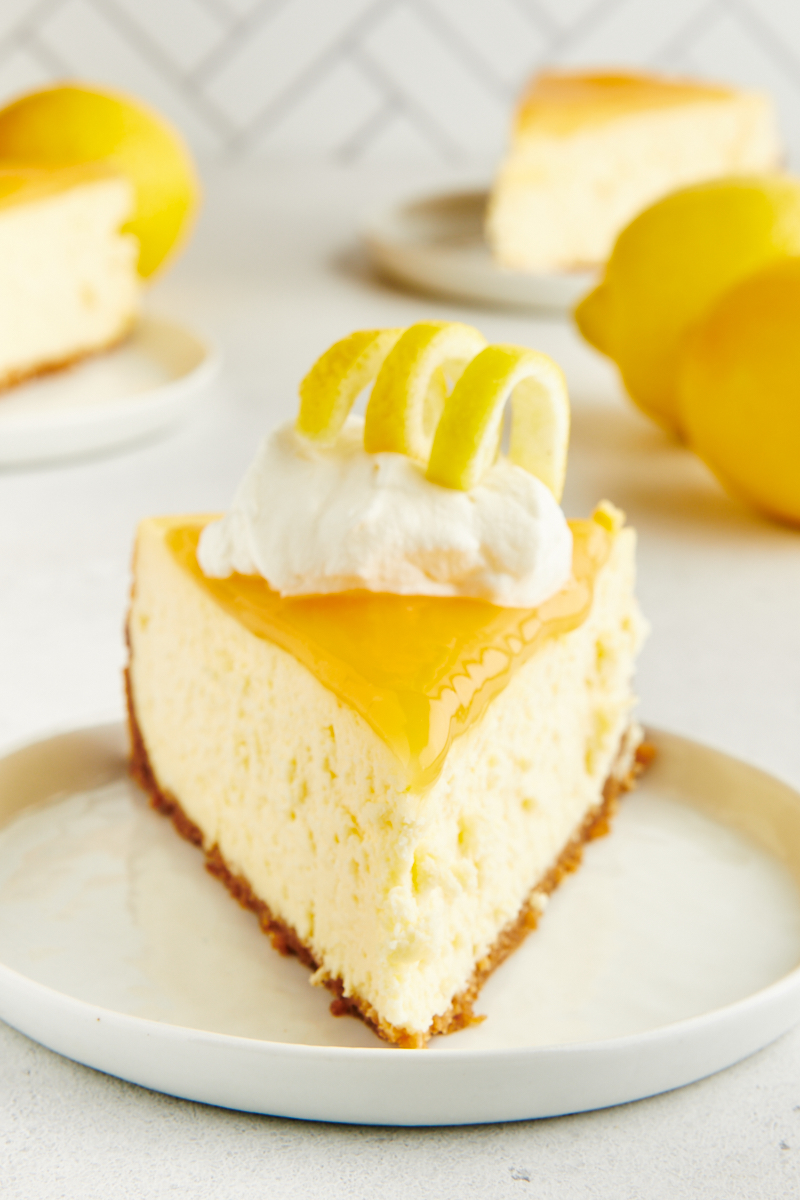 a slice of lemon cheesecake on a white plate
