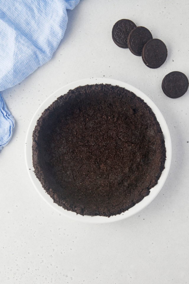 overhead view of Oreo cookie crust pressed into a pie plate