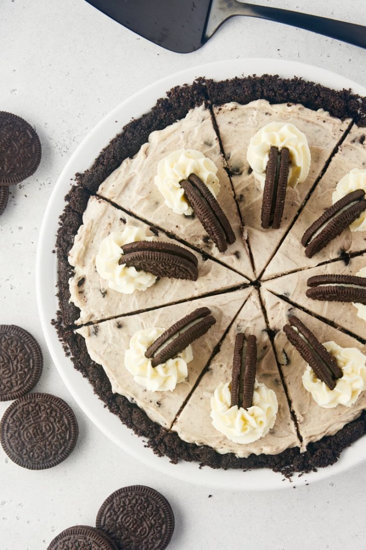 overhead view of sliced Oreo pie topped with whipped cream and more Oreos