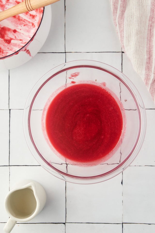 overhead view of raspberry coulis in a glass bowl