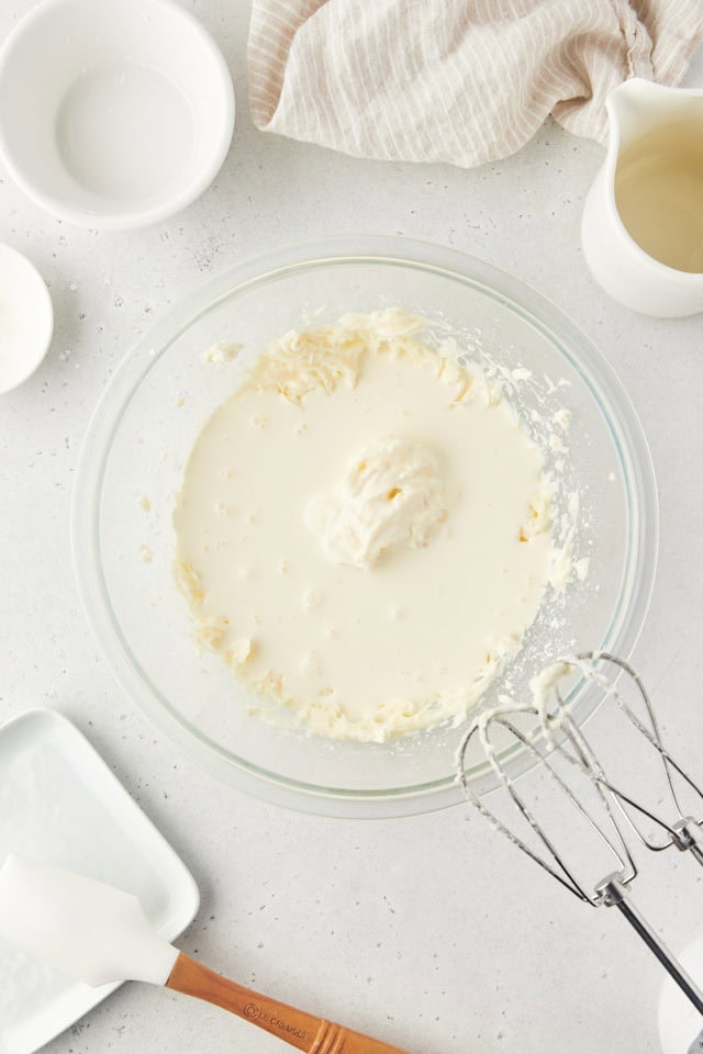 overhead view of heavy cream added to cream cheese mixture for stabilized whipped cream