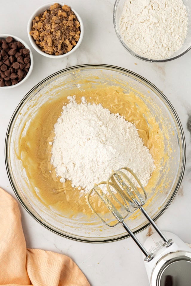 overhead view of dry ingredients added to wet ingredients for blondie cupcakes