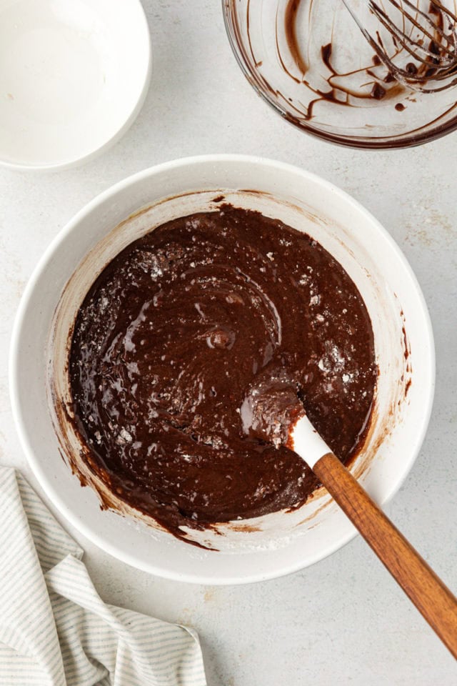 overhead view of mixed brownie batter in a glass mixing bowl