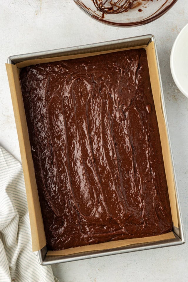 overhead view of brownie batter spread in a 9x13 baking pan