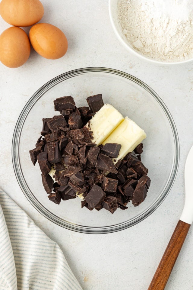 overhead view of chocolate and butter in a glass mixing bowl