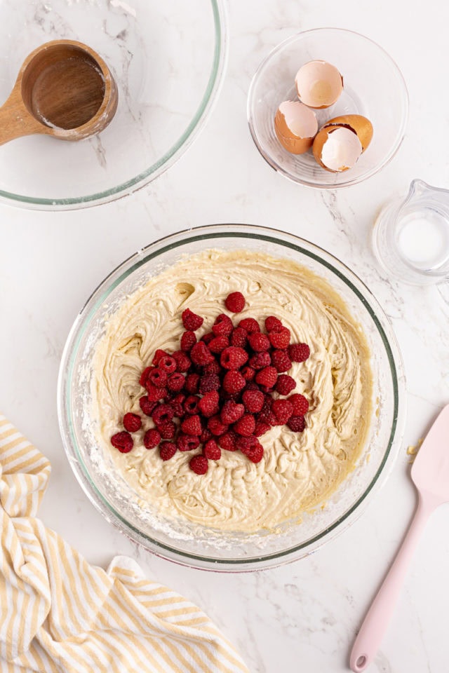 overhead view of raspberries added to cake batter