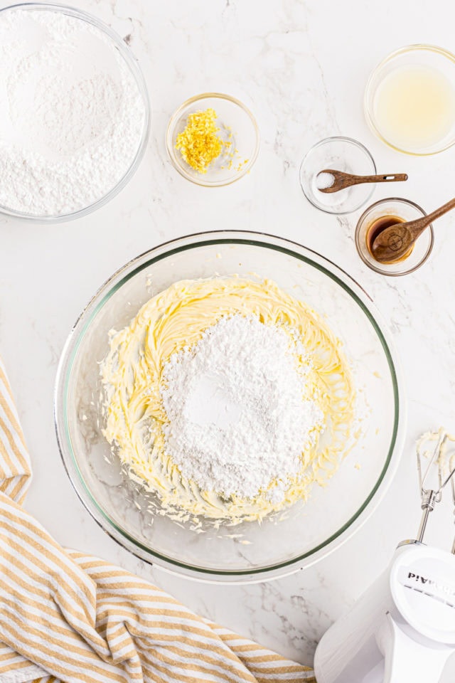 overhead view of confectioners' sugar added to creamed butter