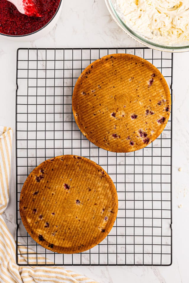 overhead view of lemon raspberry cake layers cooling on a wire rack