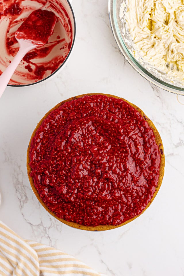 overhead view of a lemon raspberry cake topped with raspberry filling