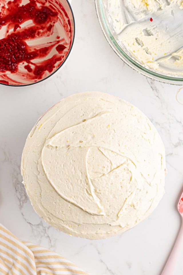 overhead view of frosted lemon raspberry cake