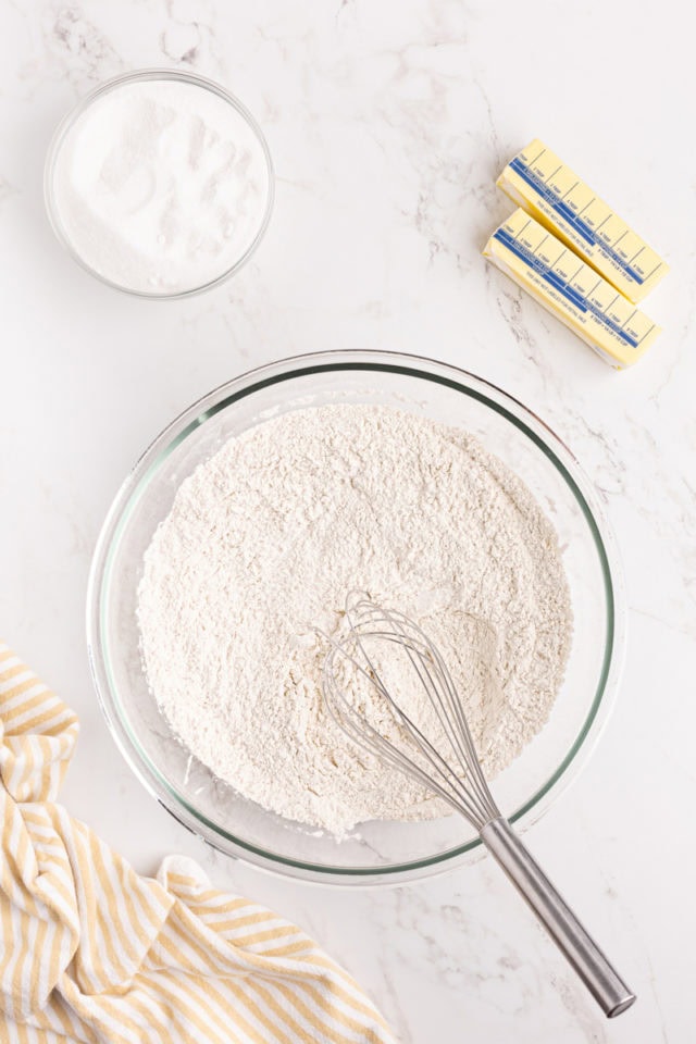 overhead view of combined flour, baking powder, and salt in a glass mixing bowl