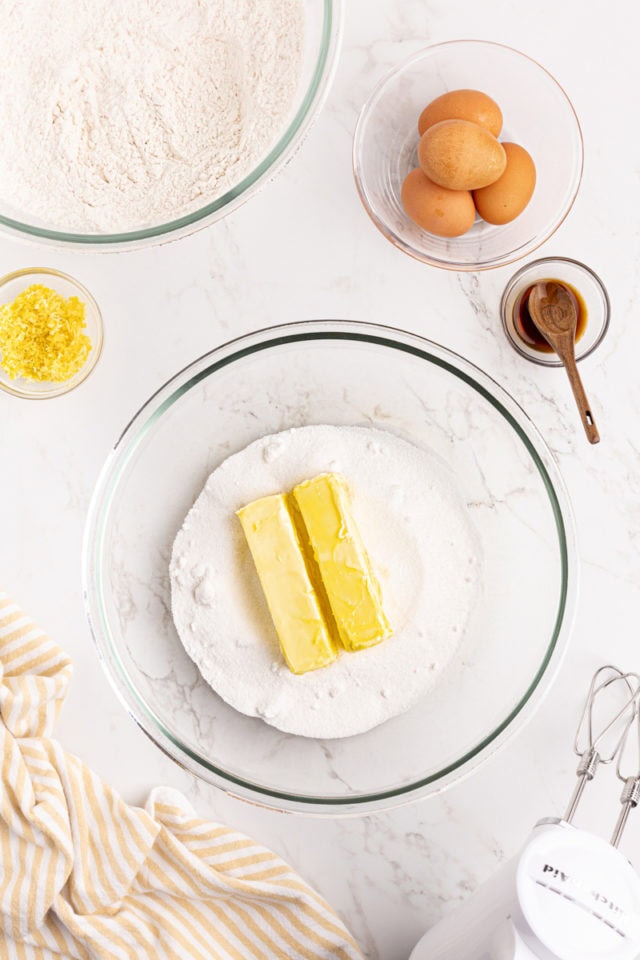 overhead view of sugar and butter in a glass mixing bowl