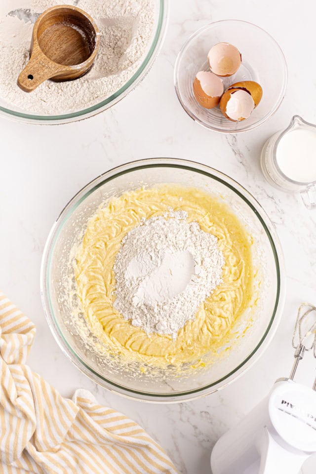 overhead view of dry ingredients added to wet ingredients for lemon raspberry cake