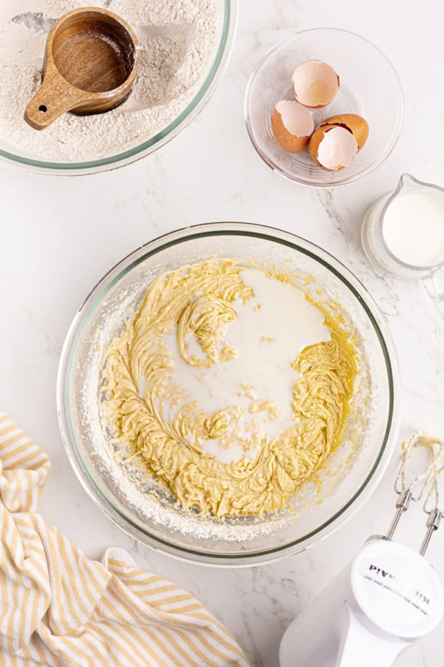 overhead view of milk added to lemon raspberry cake batter