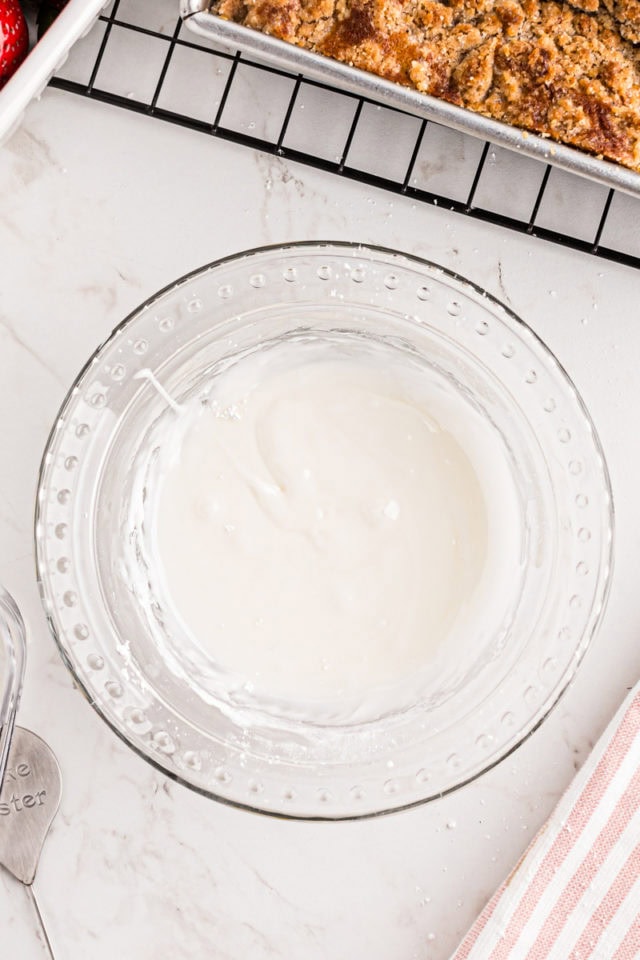 overhead view of mixed glaze for strawberry coffee cake