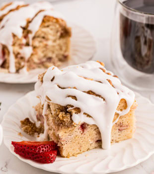 a slice of strawberry coffee cake topped with a sweet glaze