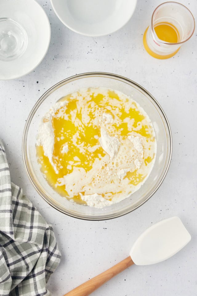 overhead view of melted butter and milk added to cobbler topping mixture