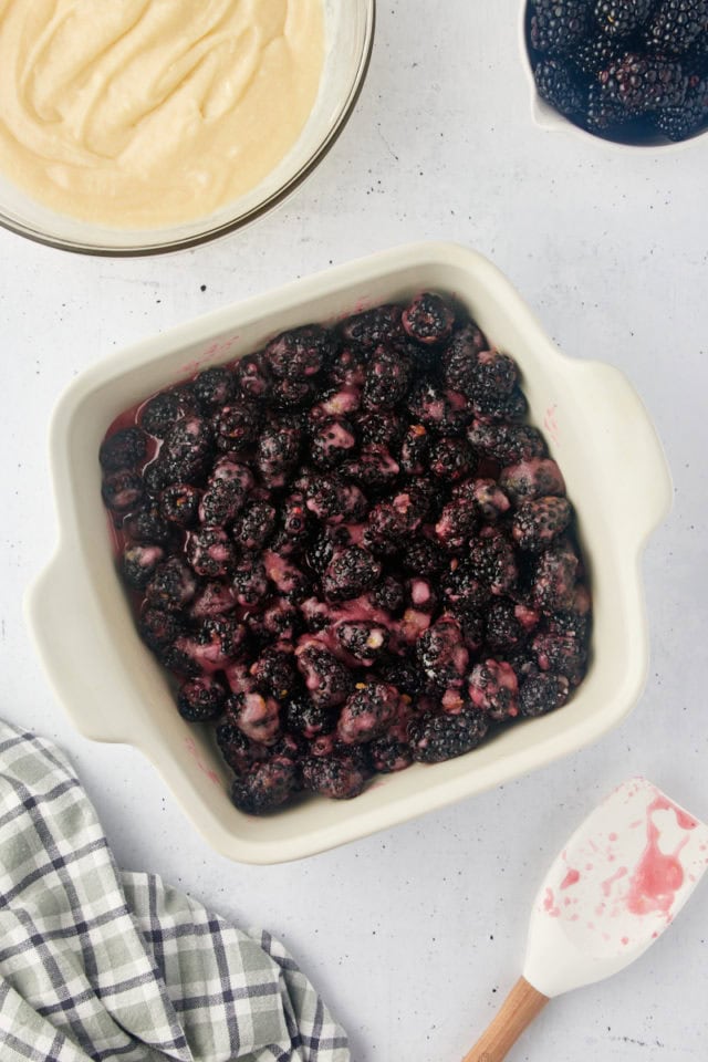 overhead view of blackberry cobbler filling in a baking pan