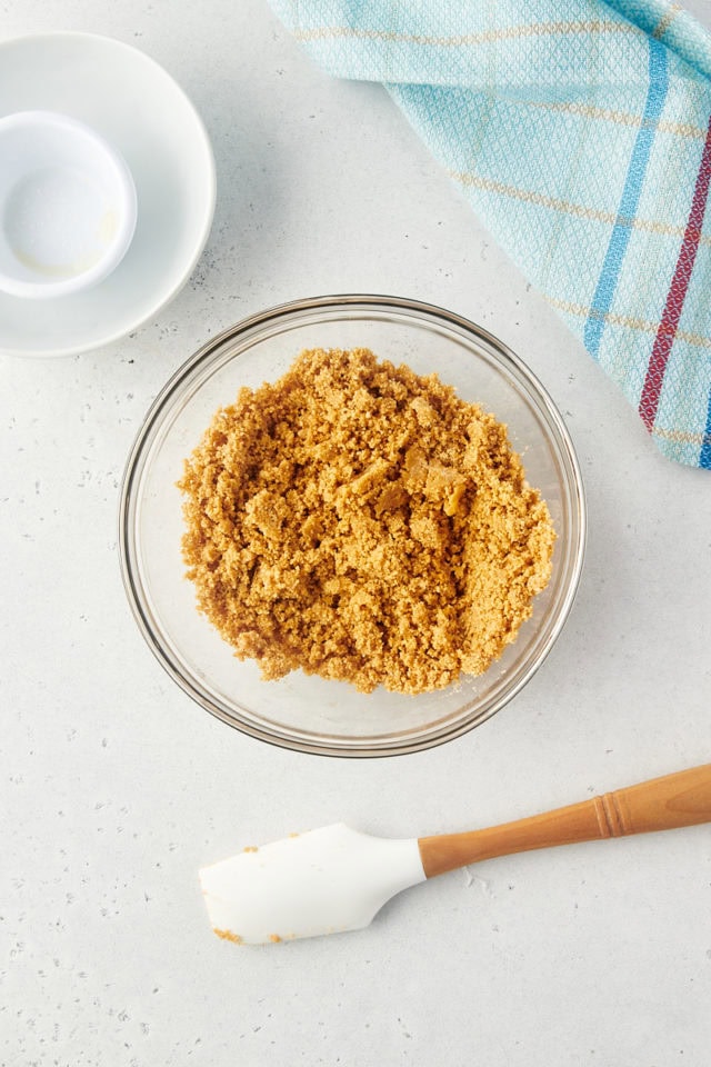 overhead view of graham cracker crumb mixture in a glass bowl