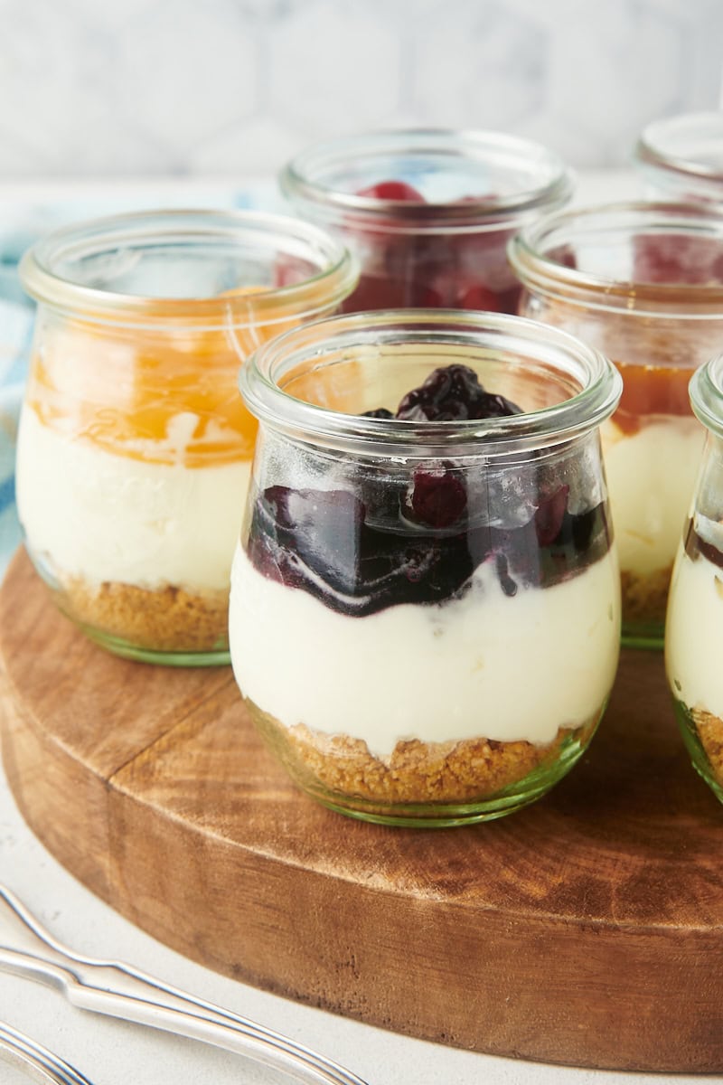 no-bake cheesecake jars on a round wooden board